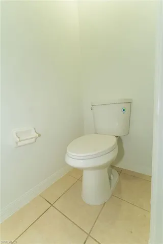 Bathroom with baseboards and tile patterned flooring