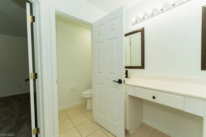 Bathroom featuring light tile patterned floors and vanity