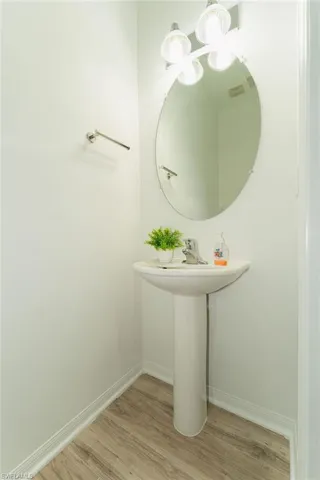 Bathroom with light wood-style floors and baseboards