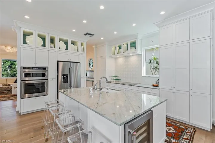 Stunning custom kitchen with impressive granite countertops, lite cabinets storage and ample storage