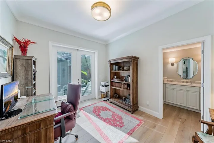 Home office featuring sink, crown molding and french doors