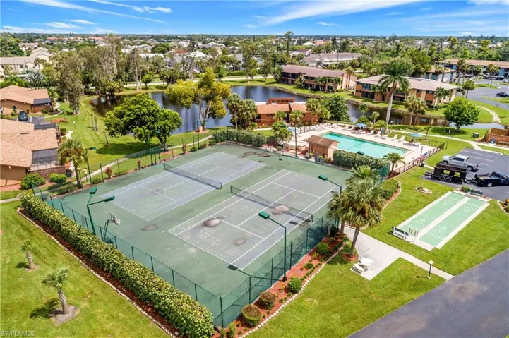 Birds eye view of property with a water view