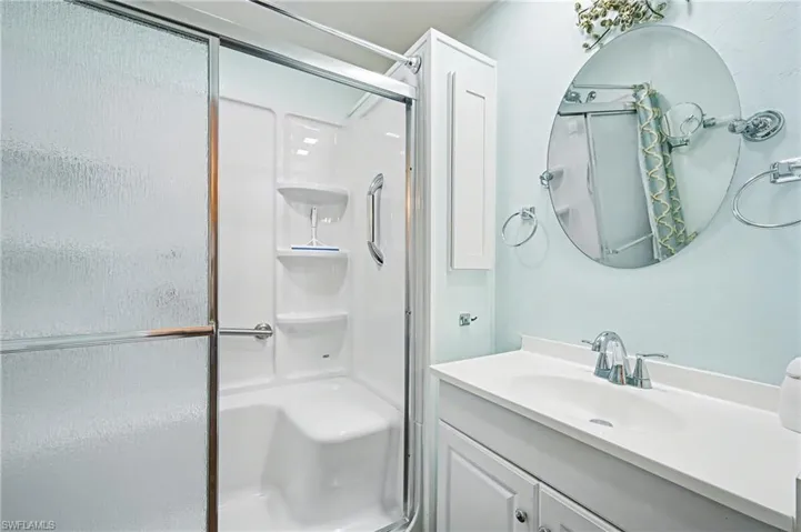 Full bathroom featuring vanity and a shower stall