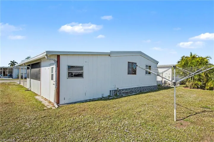 View of side of property featuring a lawn