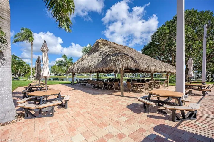 View of home's community featuring outdoor dining area and a patio area
