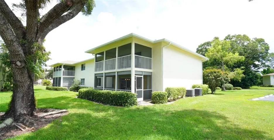 Rear view of house featuring a screened lanai and short walk to the pool.