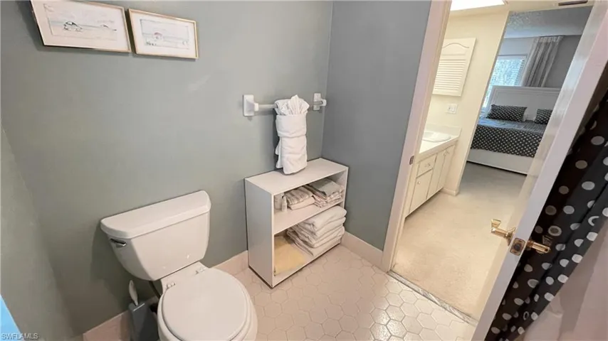 Ensuite bathroom featuring vanity and light colored tile.