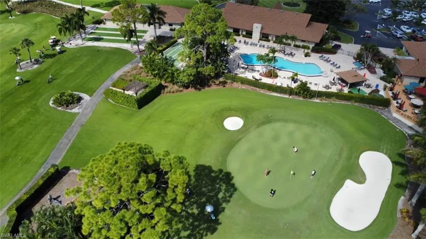 Aerial view of main pool, clubhouse, bocce courts, shuffleboard, admin building, 19th hole restaurant and 9th green of the Palmetto golf course.