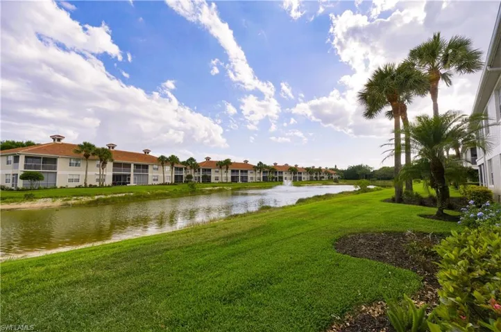 Waterfront buildings featuring terra cotta roof tiles and screened lanais