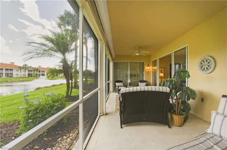 Expansive screened patio featuring a ceiling fan, recessed lighting, and multiple sliding glass doors