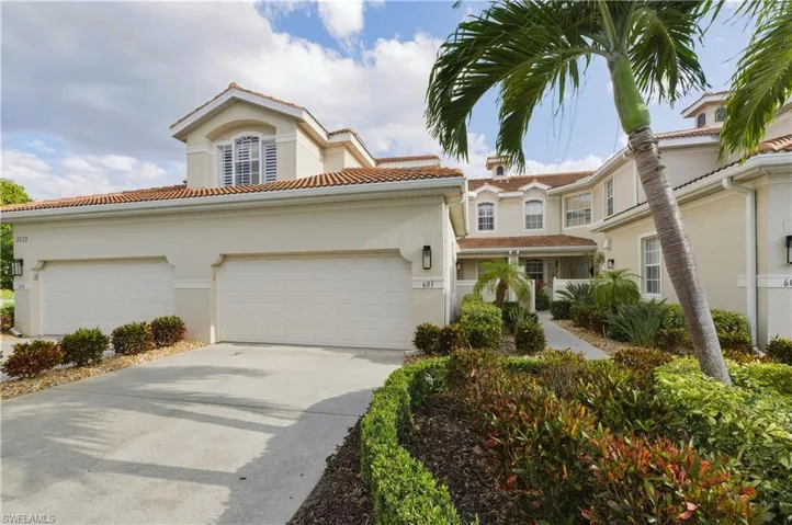 Mediterranean-inspired exterior with a terracotta tile roof and stucco finish
