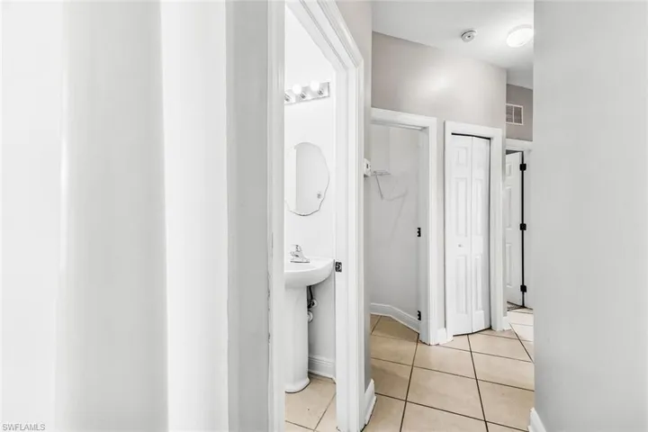 Bathroom with tile patterned floors and baseboards