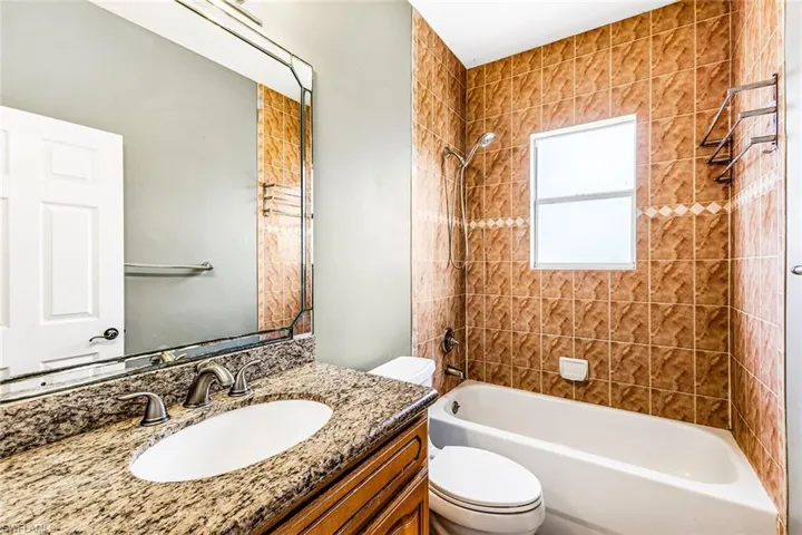 Full bath with toilet, bathing tub / shower combination, and vanity