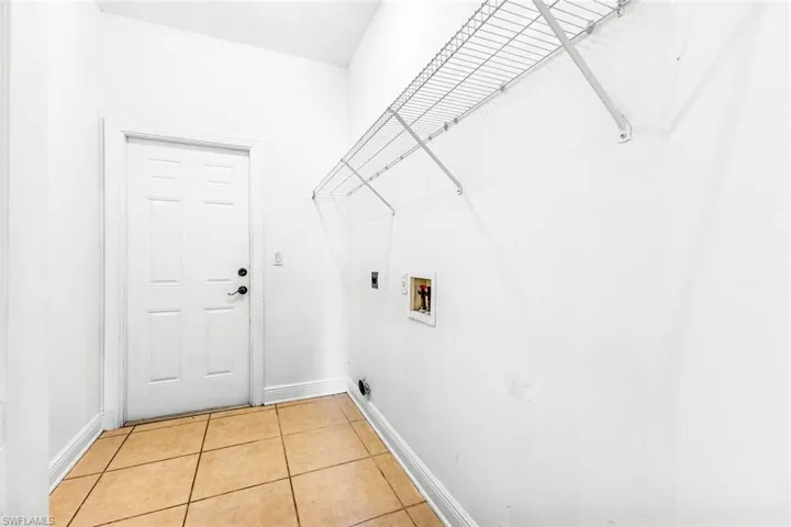 Laundry area featuring washer hookup, baseboards, hookup for an electric dryer, and light tile patterned floors