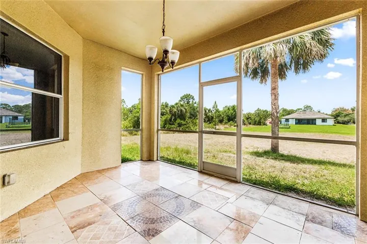 Unfurnished sunroom with a chandelier