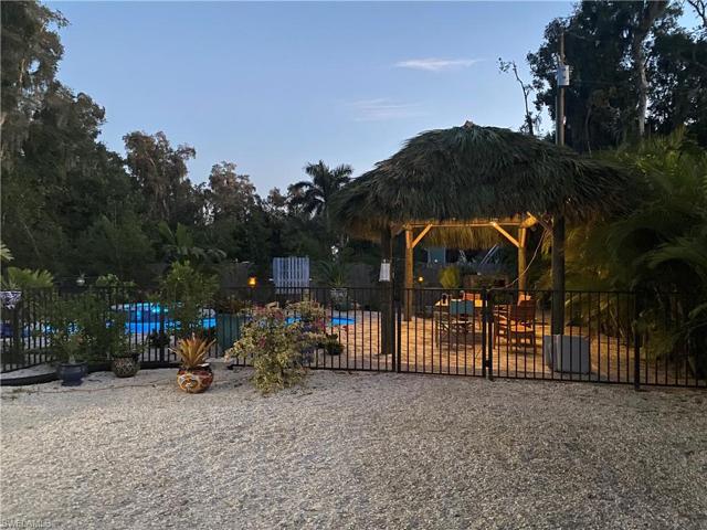 Tiki hut and pool in evening