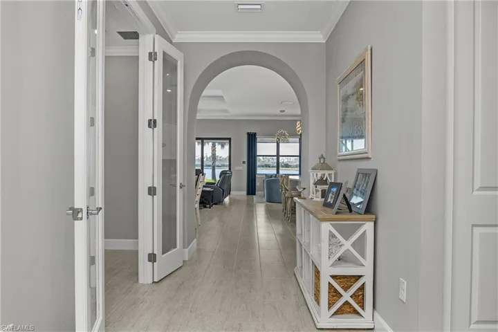 Welcoming foyer with timeless tile throughout the home and crown molding adding a more custom touch to the home.