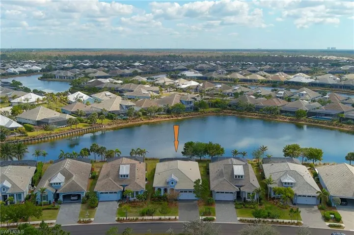 Birds eye view of property with a water view