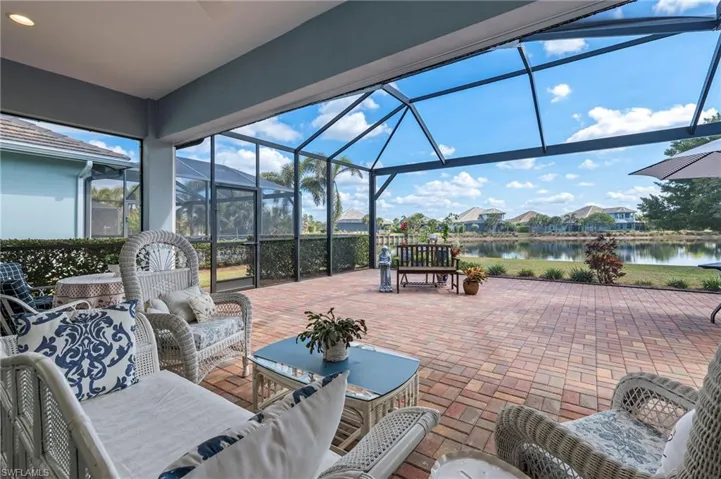 View of patio / terrace featuring an outdoor living space, a water view, and glass enclosure
