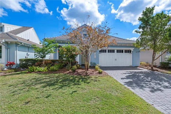 View of front of home featuring a garage and a front lawn