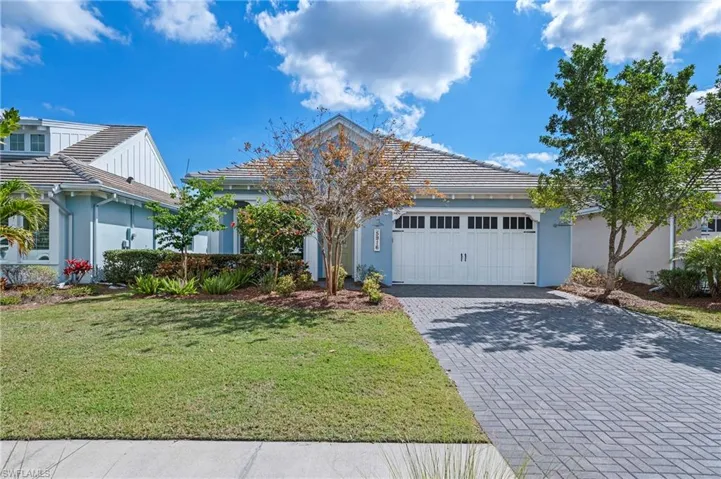 View of front of property with a garage and a front yard