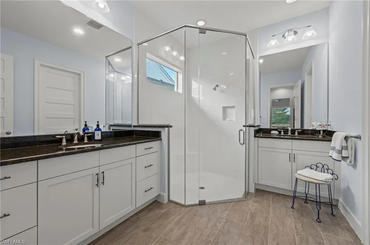Bathroom with vanity and a shower with shower door