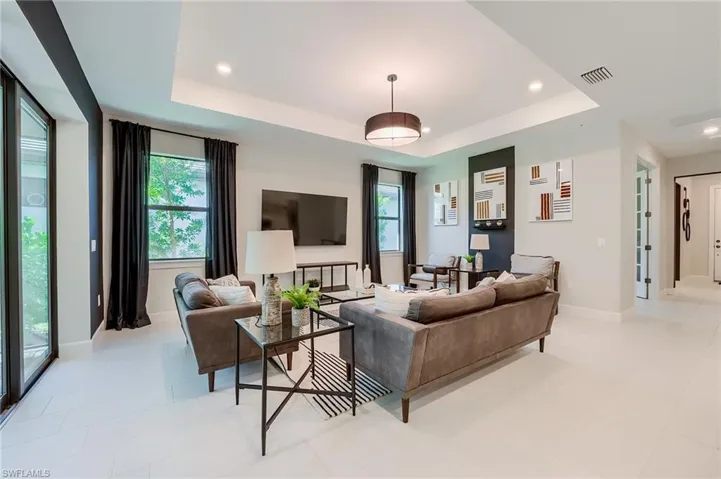 Living room featuring a tray ceiling