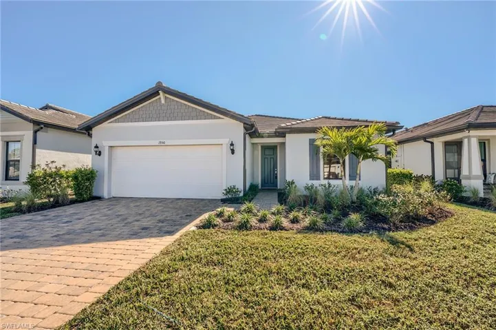 Single story home with a front yard and a garage