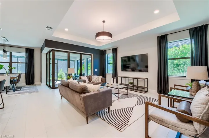 Living room featuring a raised ceiling