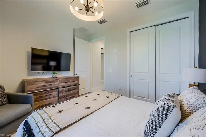 Bedroom featuring a closet and an inviting chandelier