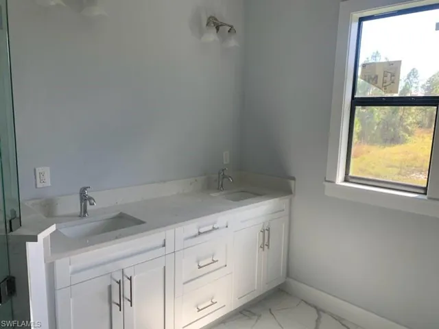 Bathroom featuring vanity and a healthy amount of sunlight