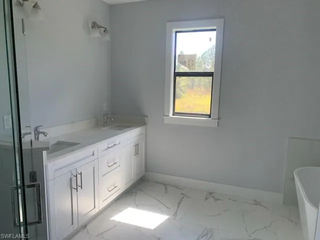 Bathroom with vanity and a washtub