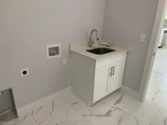 Laundry room with cabinets, hookup for an electric dryer, sink, and washer hookup