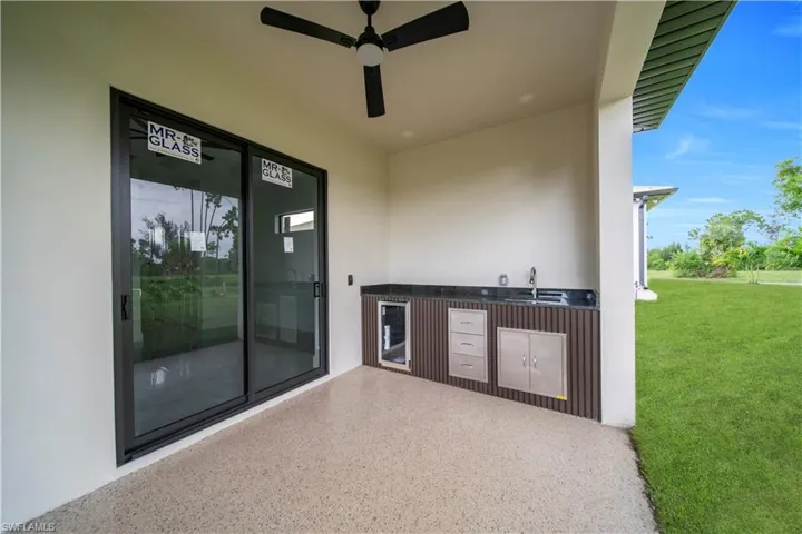 View of patio featuring wine cooler and a ceiling fan