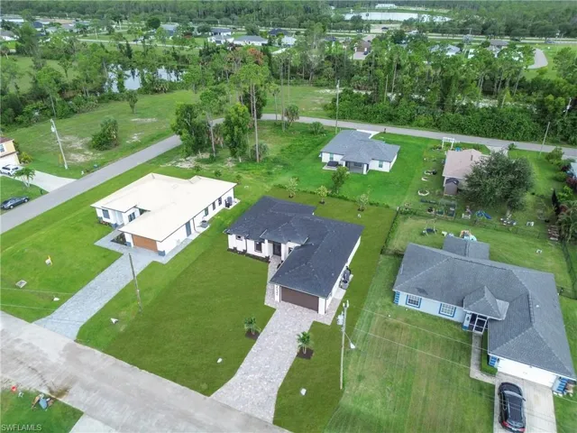Aerial perspective of suburban area featuring a nearby body of water