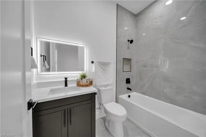 Full bath featuring vanity and  shower combination
