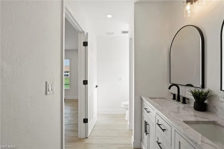 Bathroom with vanity, toilet, and hardwood / wood-style floors