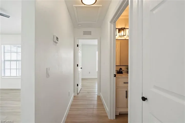 Hall with light hardwood / wood-style floors