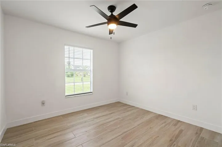 Spare room featuring ceiling fan and light hardwood / wood-style floors