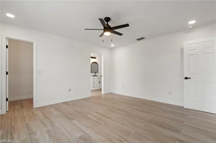 Empty room featuring light hardwood / wood-style flooring and ceiling fan