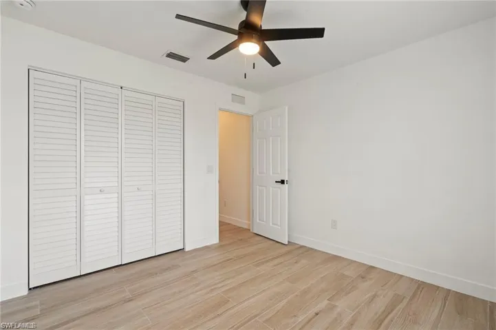 Unfurnished bedroom with a closet, ceiling fan, and light hardwood / wood-style floors