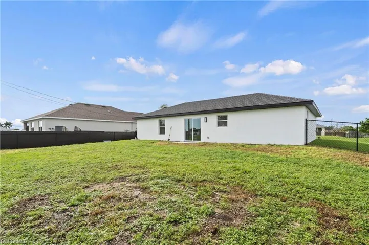 Rear view of house with a lawn