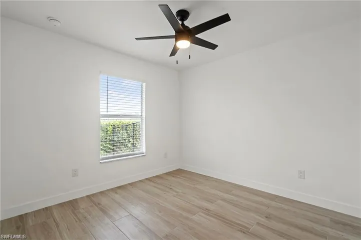 Spare room featuring ceiling fan and light hardwood / wood-style flooring
