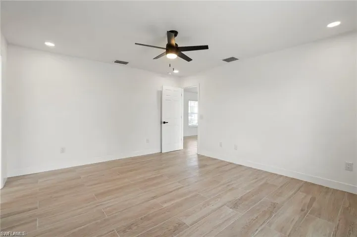 Spare room featuring ceiling fan and light hardwood / wood-style floors