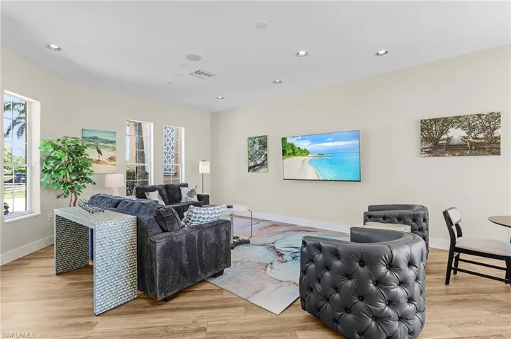 Living room featuring visible vents, recessed lighting, light wood-style flooring, and baseboards