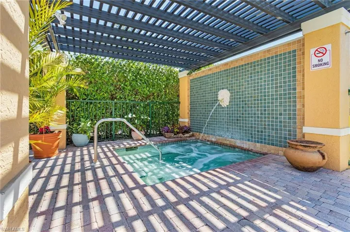 View of pool featuring a hot tub and a pergola