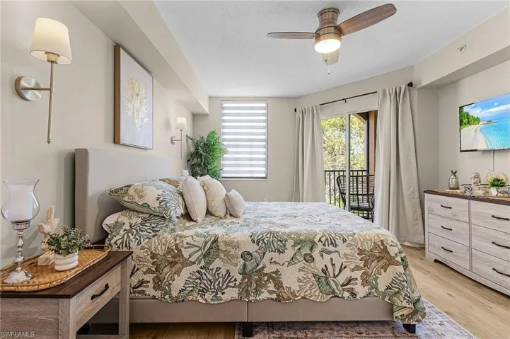 Bedroom featuring access to outside, a textured ceiling, and light wood finished floors