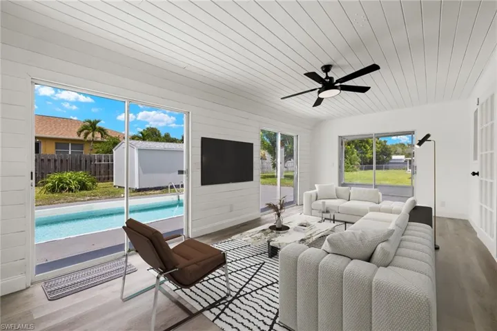 Living room featuring wood ceiling, light wood-type flooring, and ceiling fan
