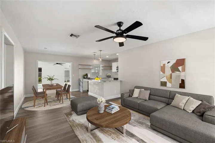 Living room featuring wood-type flooring and ceiling fan
