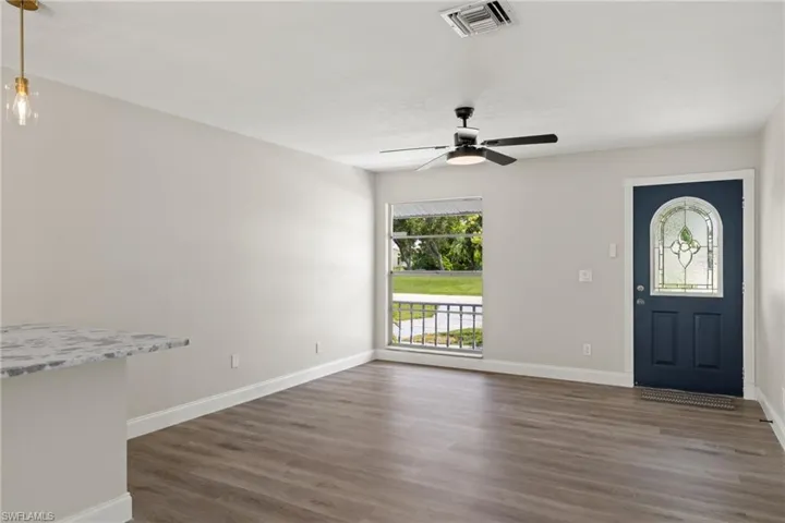 Foyer with hardwood / wood-style flooring and ceiling fan
